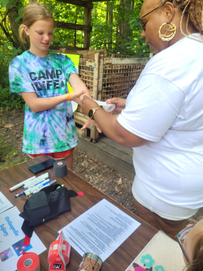 LaTonja Lee, a Black woman, demonstrates how to wrap a wrist.